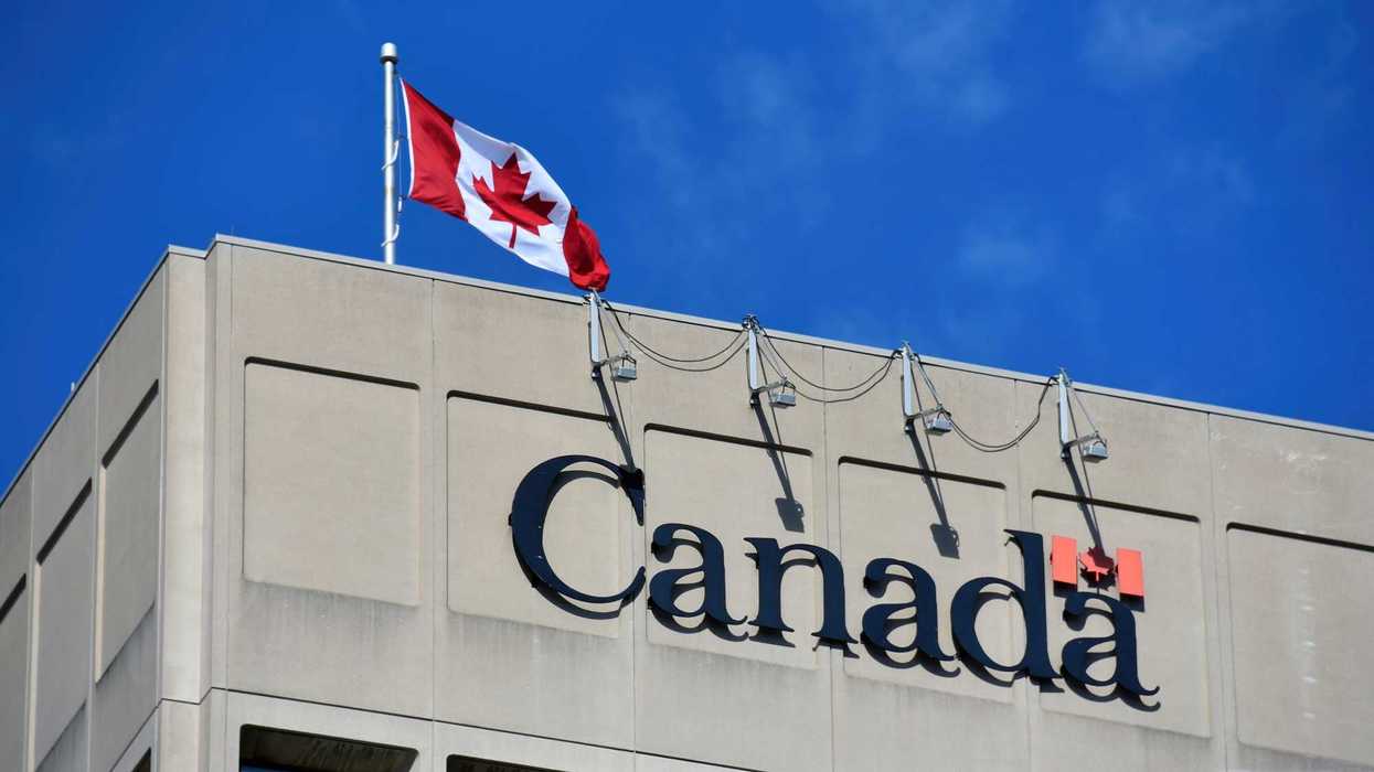 Cinderblock building with Canadian flag and Canada wordmark.