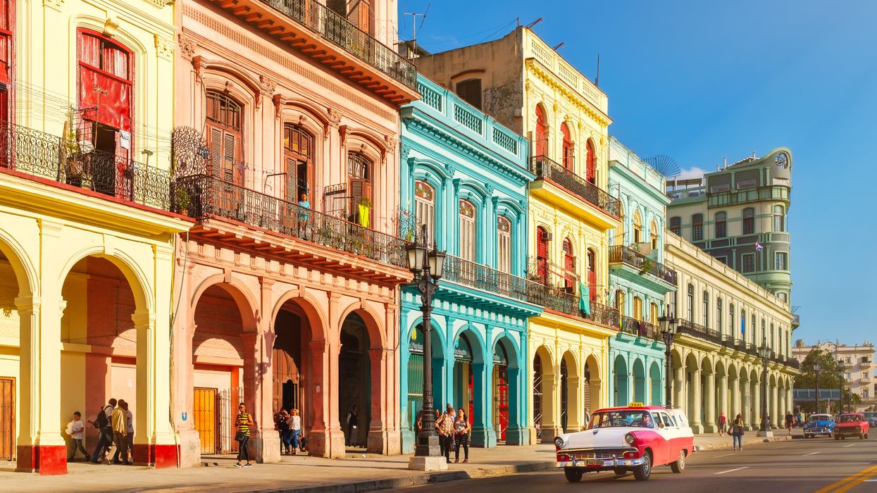 Classic old cars and colourful buildings in downtown Havana, Cuba.