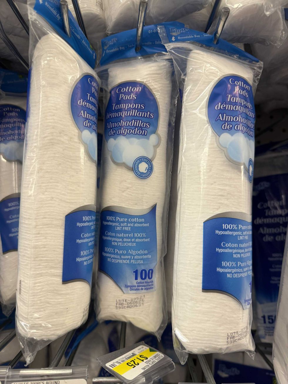Clear bags with white pads in them blue labels reading Cotton pads on them.