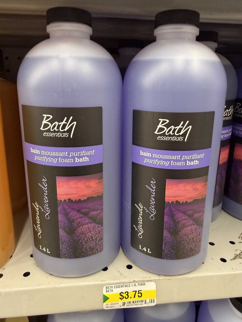 Clear bottles with purple liquid in them and a label reading Bath essentials purifying foam bath in lavender.
