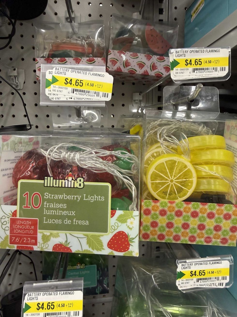 Clear boxes with colourful outdoor lights in the shape of strawberries and lemons.