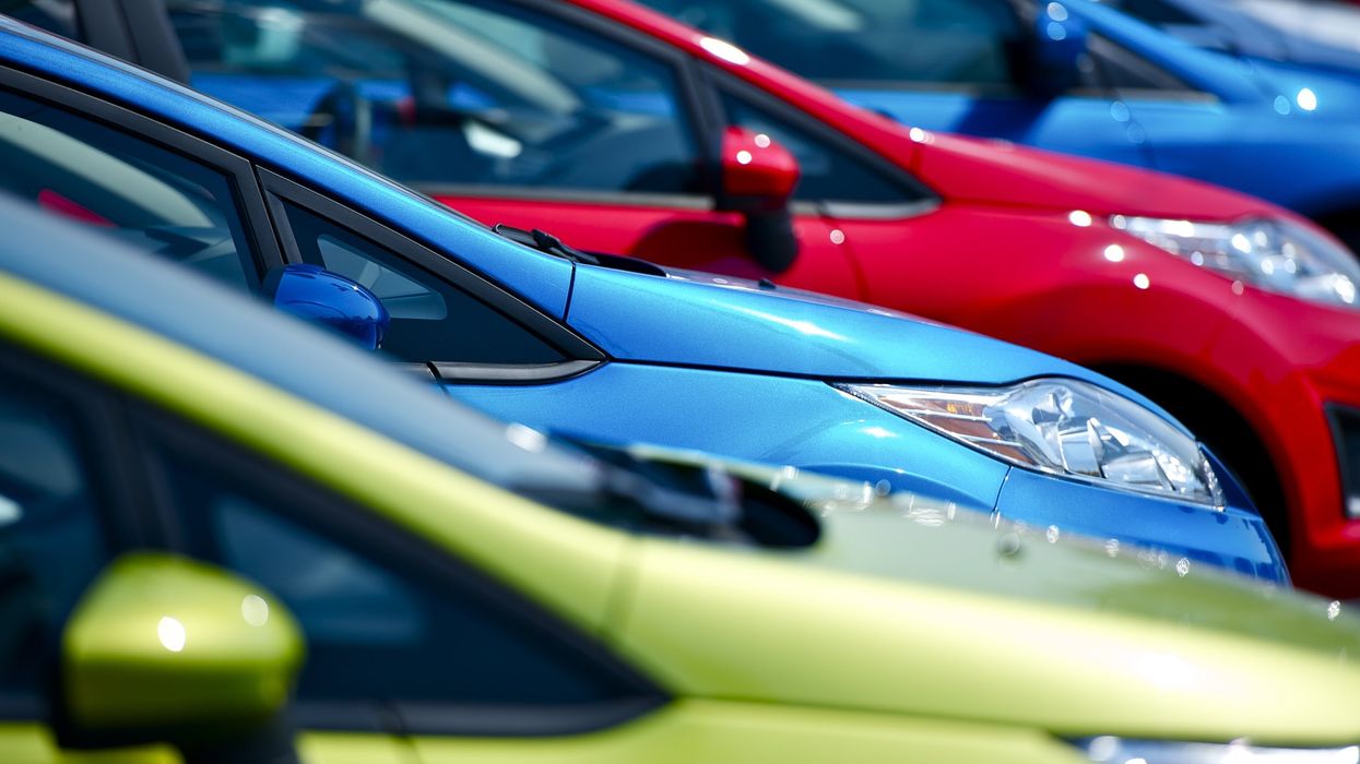 Close-up of a few colourful cars parked in a lot (illustrative).