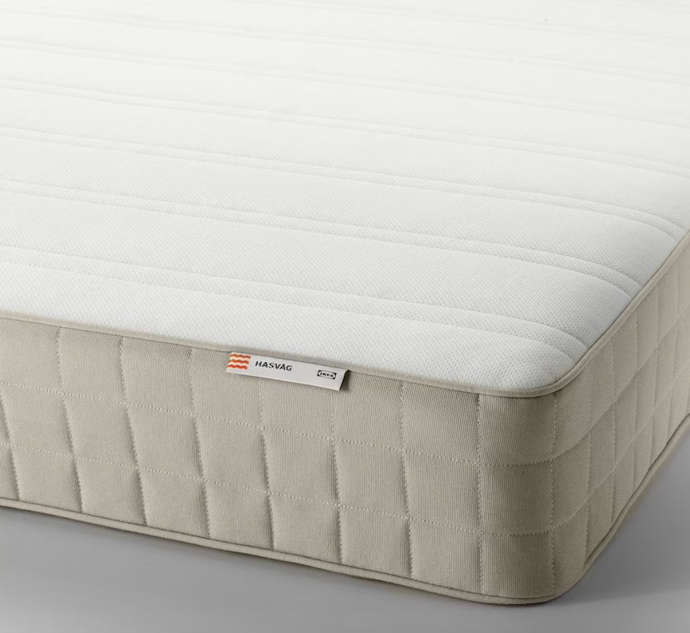 Closeup of a beige and white mattress.