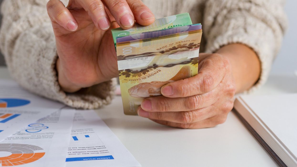 Closeup of hands holding Canadian money.