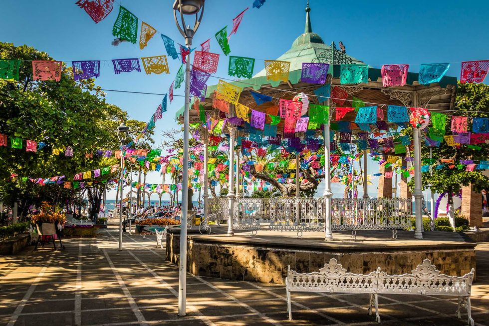 Coloured flags decorate the Malec\u00f3n in Puerto Vallarta.