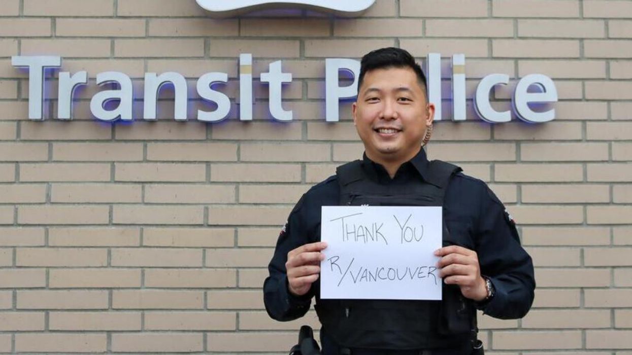 Constable Peter Kwok holding a sign, thanking Vancouver Reddit.