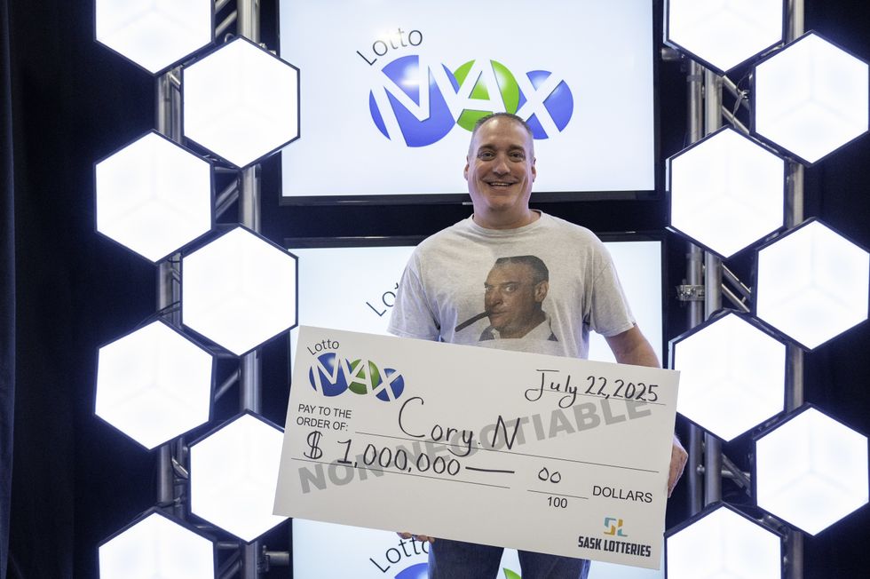 cory nickason holding a $1 million lotto max cheque