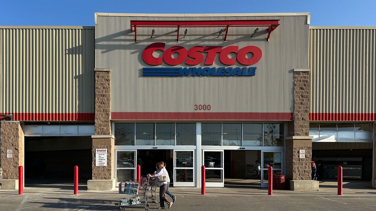 costco warehouse shopper pushing a cart