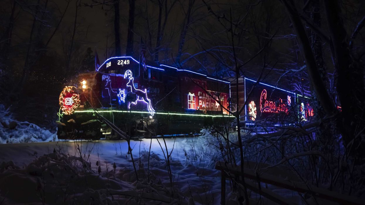 cpkc holiday train lit up on snow covered tracks in bc