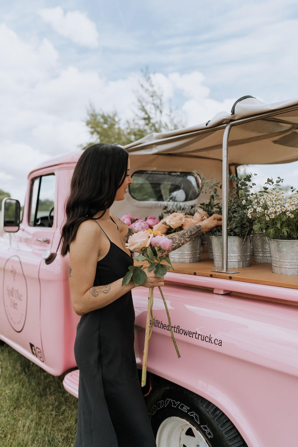 Creating a bouquet of flowers from a vintage pink truck.