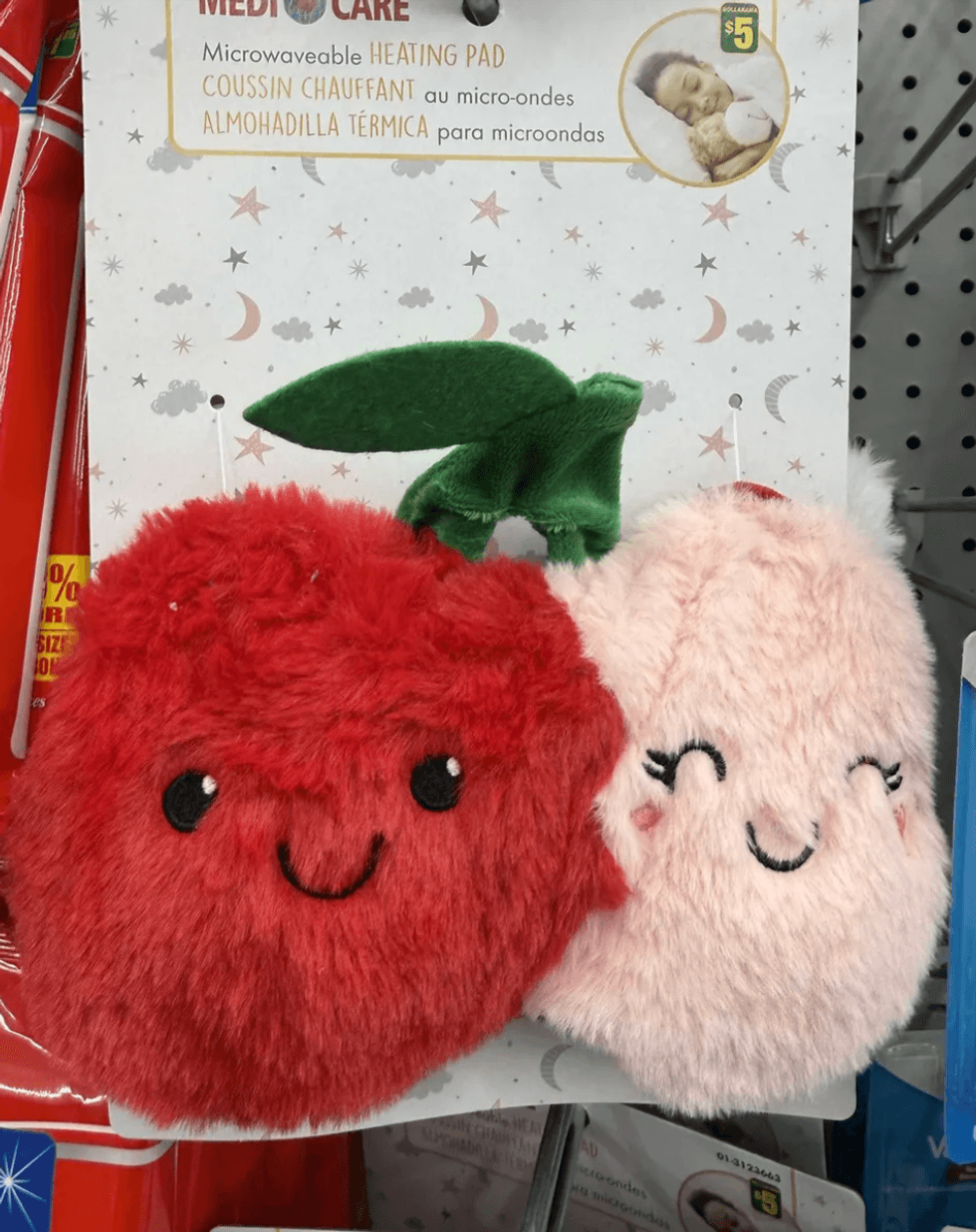 Cute, fluffy red and pink microwavable heating pads with smiling faces.