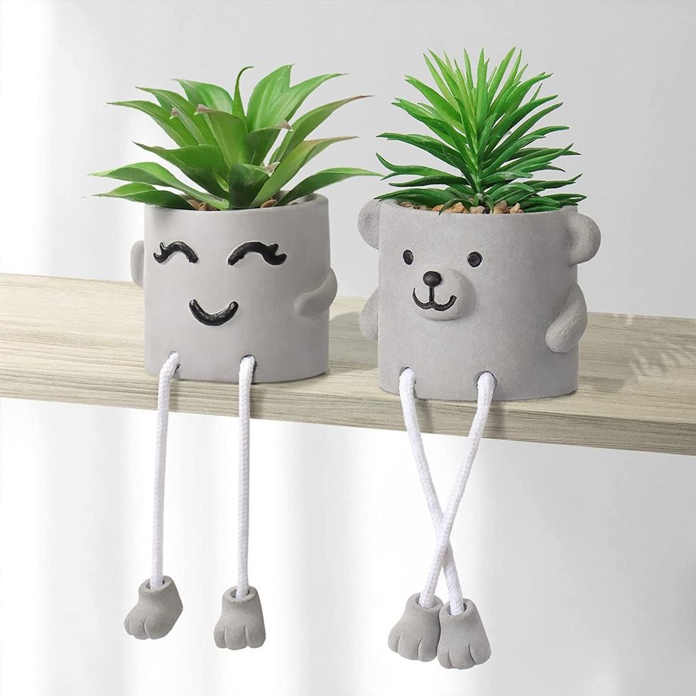 Cute planters with faux succulents.