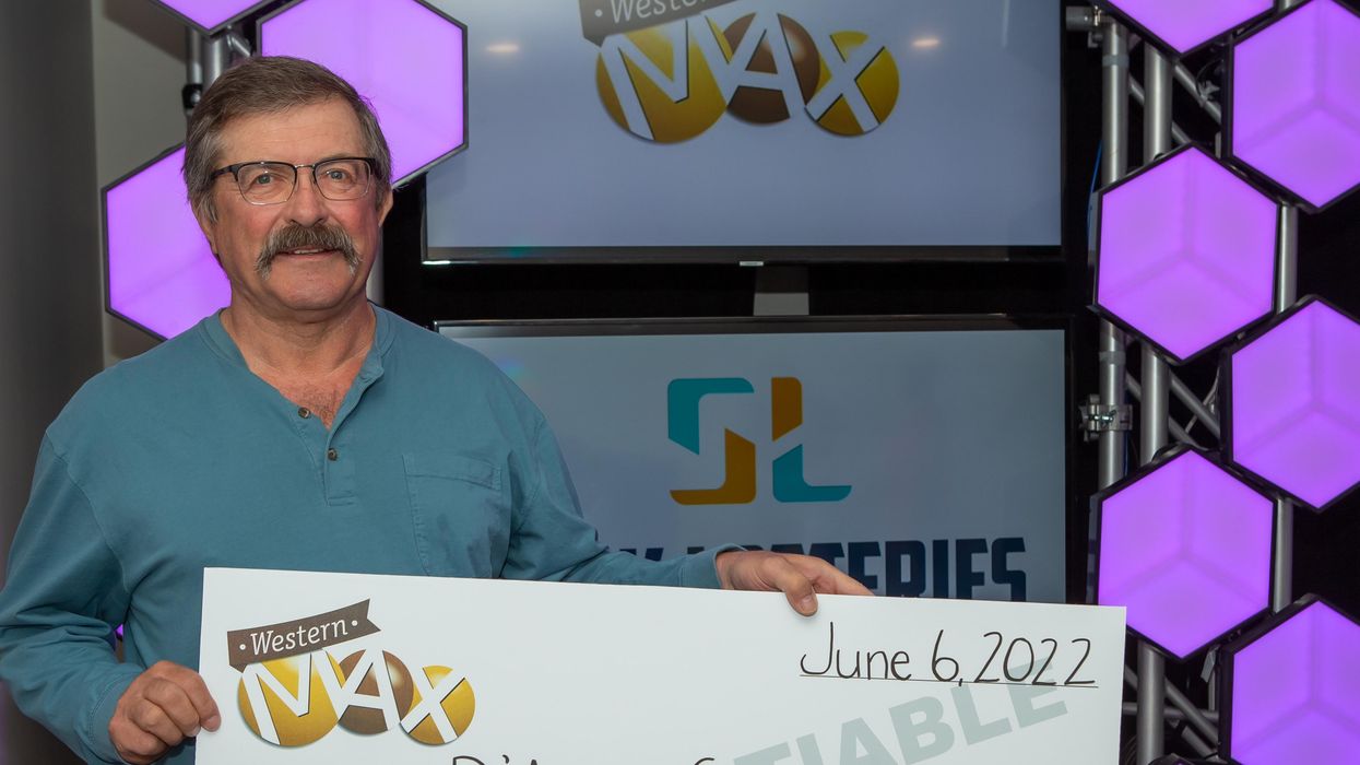 D'Arcy Glover holding a cheque.