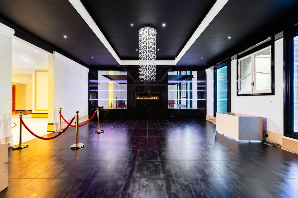 Dancefloor with fireplace and velvet rope.