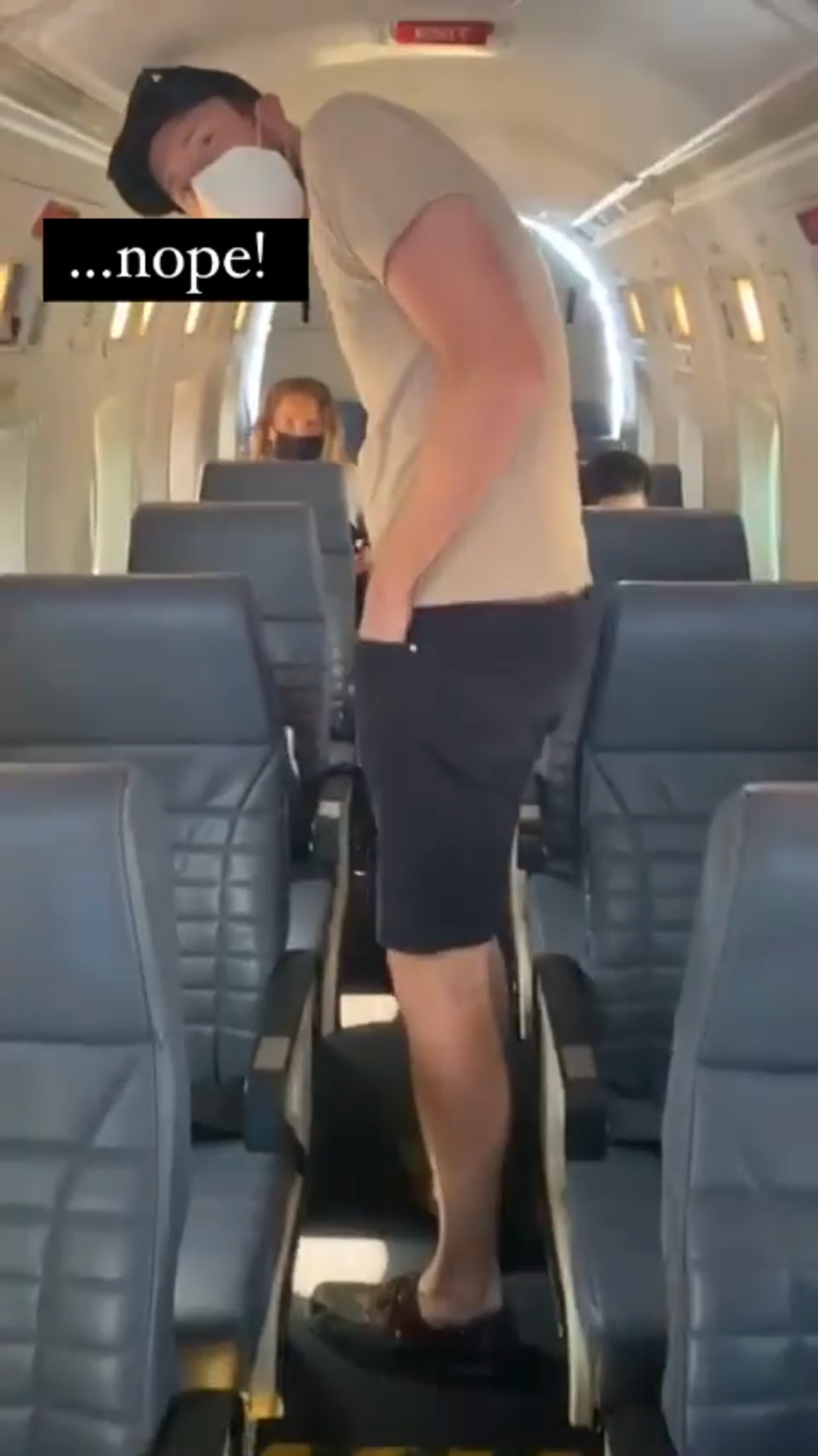 Daniel hunches over in a Pacific Coastal Airlines plane.