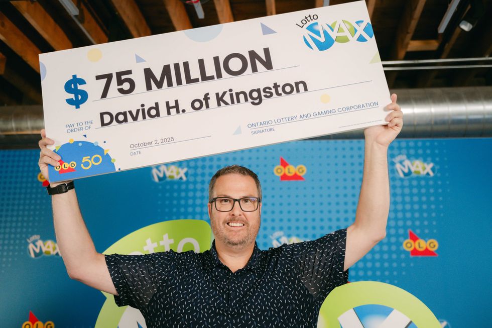david hatt holding a $75 million lotto max cheque