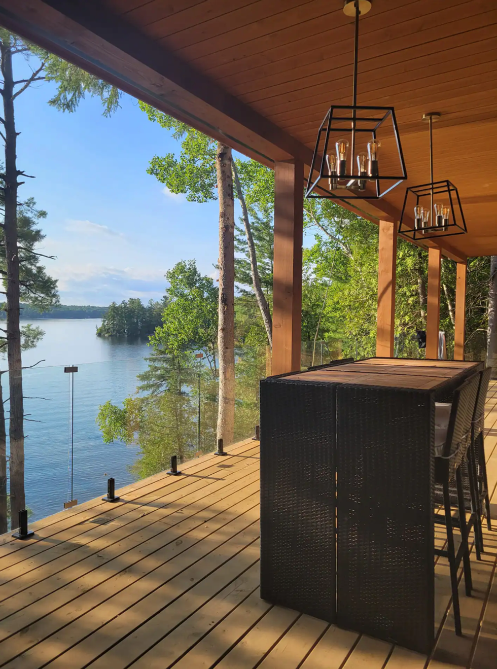 Deck with a table overlooking the water.