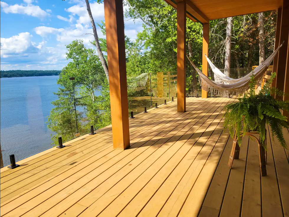 Deck with two hammocks and water views.