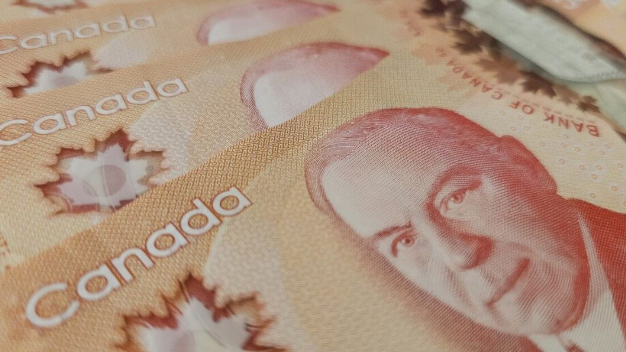 Des billets de 50 $ sont placés en éventail sur une surface plane.