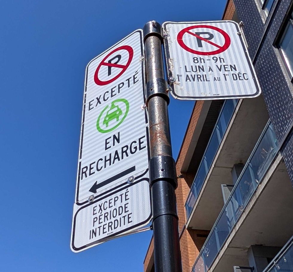 Des panneaux indiquant l\u2019interdiction de stationner dans une zone publique de recharge pour v\u00e9hicules \u00e9lectriques.