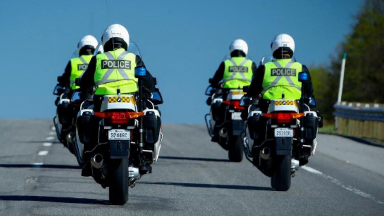 Des policiers de la Sûreté du Québec en moto sur la route.