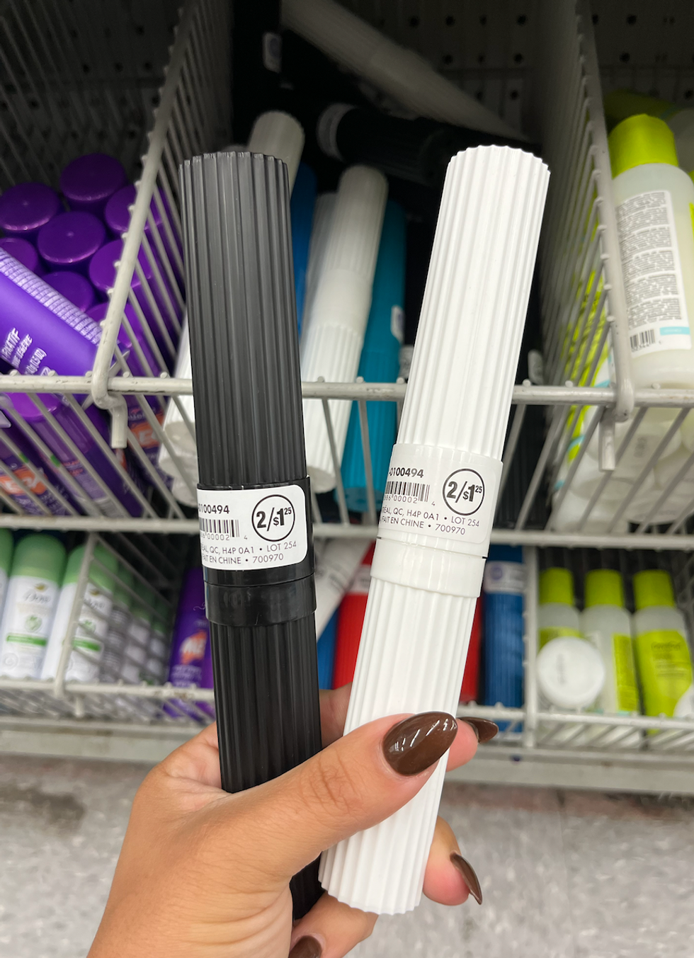 Deux bo\u00eetiers \u00e0 brosse \u00e0 dents, un noir et un blanc, en plastique.