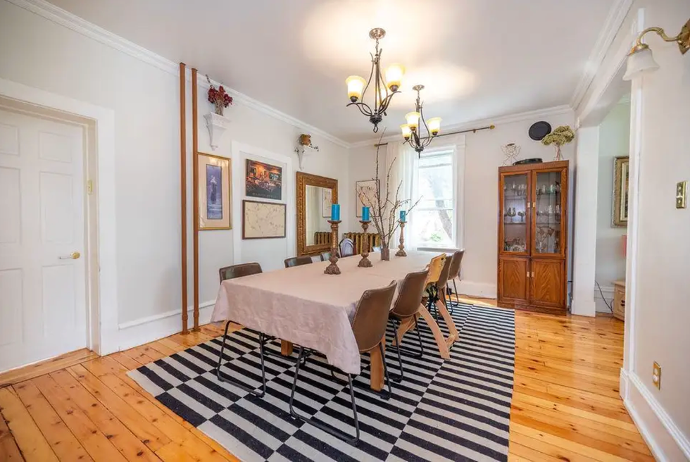 Dining room with a table and candles.