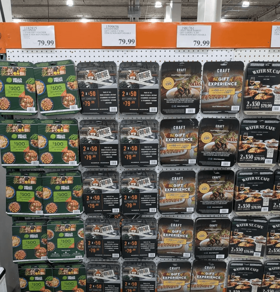 Display of various restaurant gift cards on a store shelf, priced at $79.99.