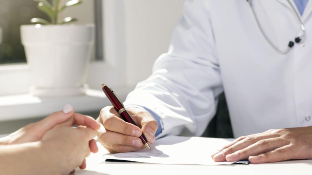 Doctor signing a form.