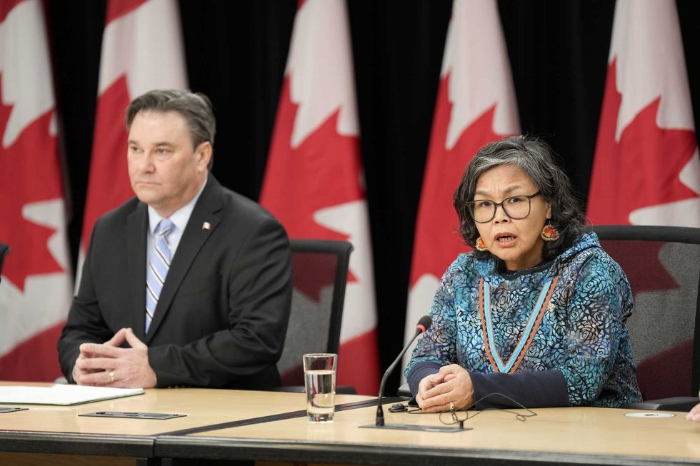 Don Davies and Lori Idlout sit at a table.