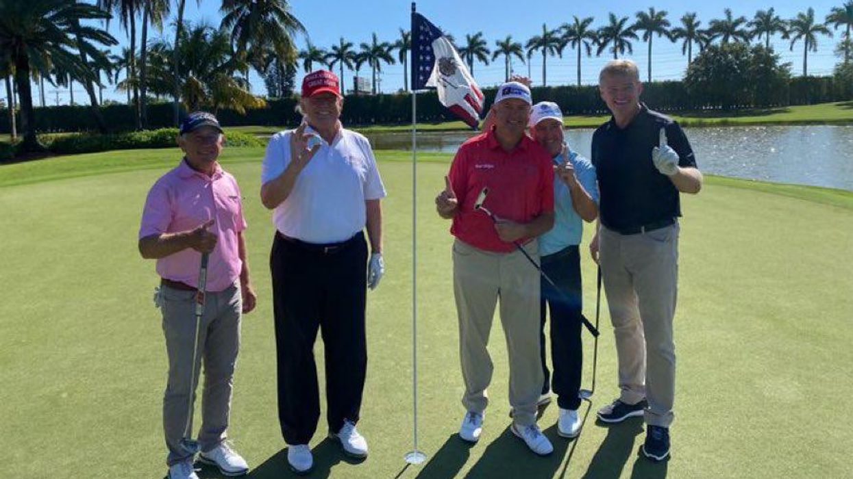 Donald Trump and company play golf.