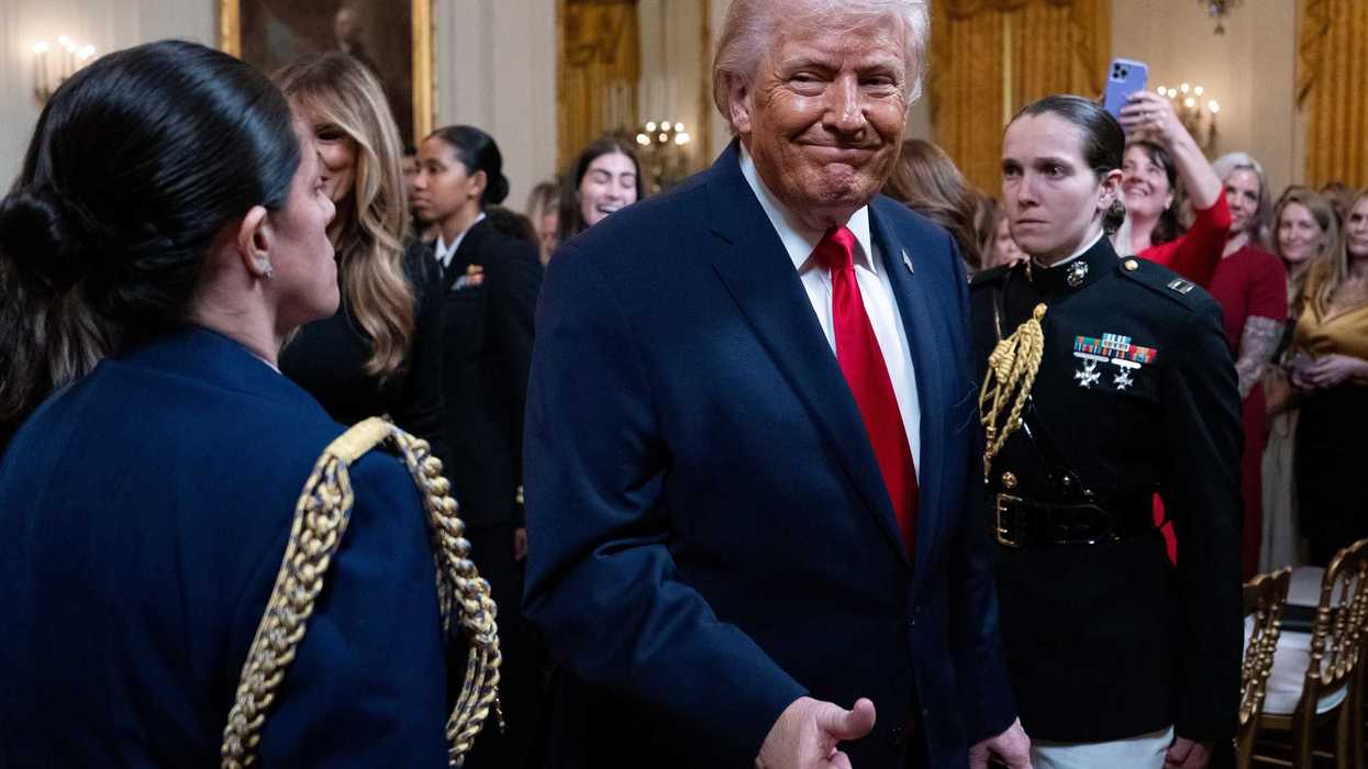 Donald Trump gives a thumps-up in the East Room of the White House.