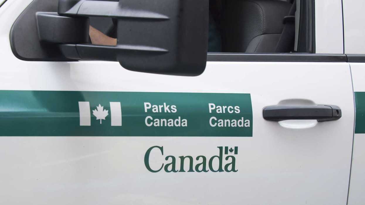 door of parks canada vehicle with green and white logo