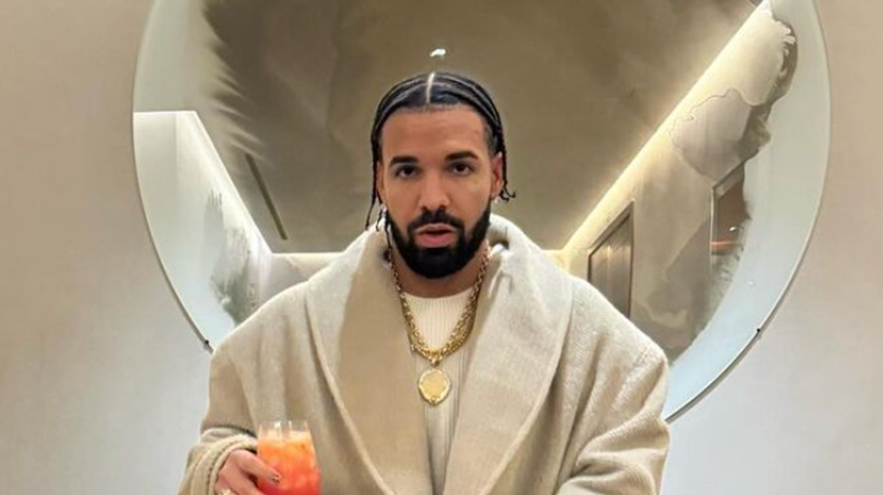 Drake holding a drink.