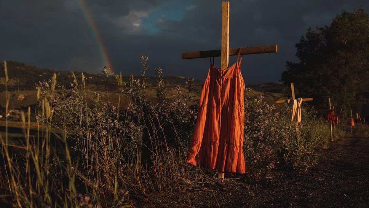 Dresses hanging on wooden crosses at the site of the Kamloops Residential School.