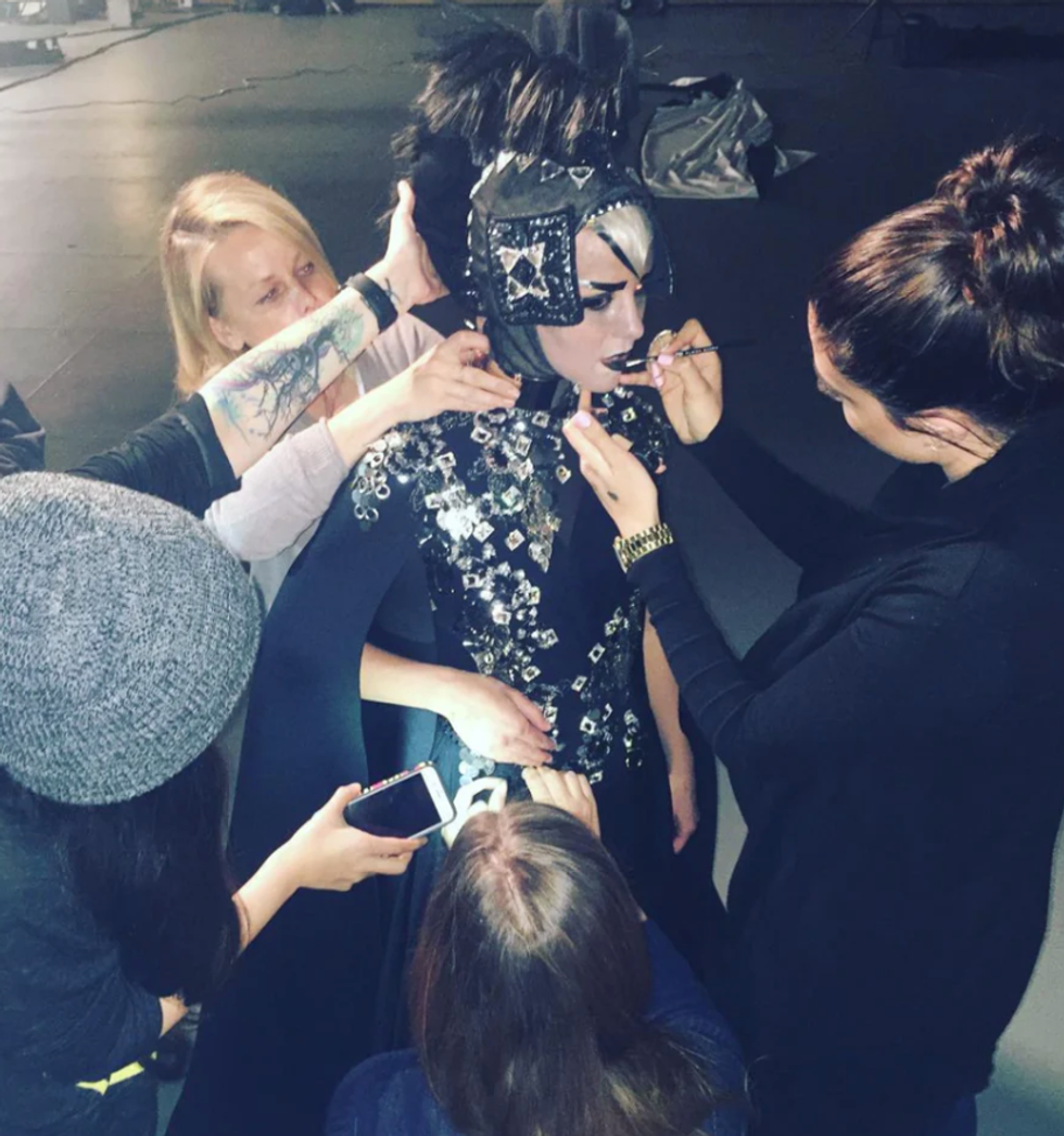 Elaina Badro applying makeup on a model.