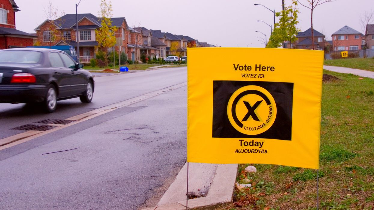 elections ontario sign outside a polling place that says "vote here"