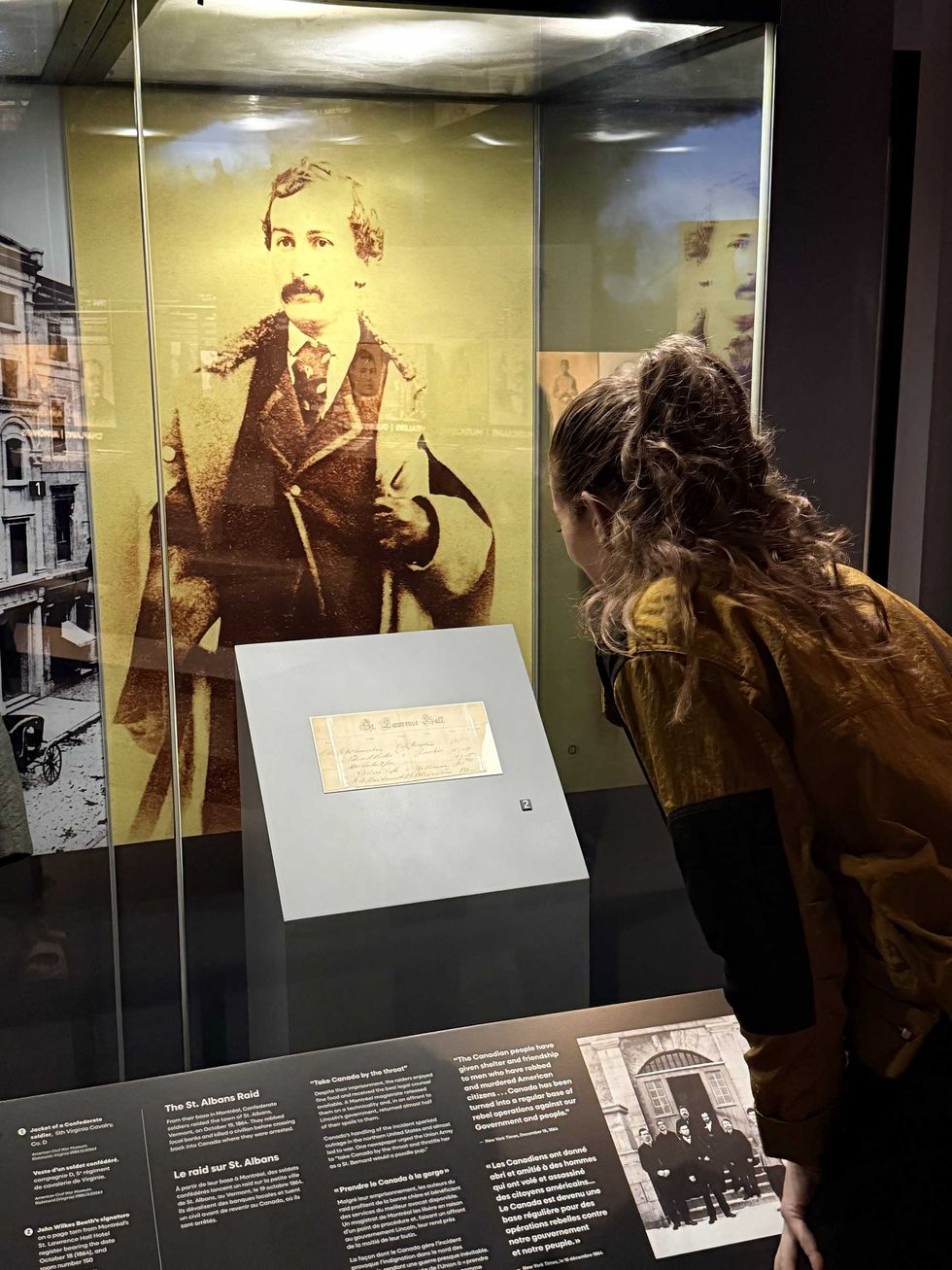 Elisha Barry looks at a Montreal hotel register signed by John Wilkes Booth.