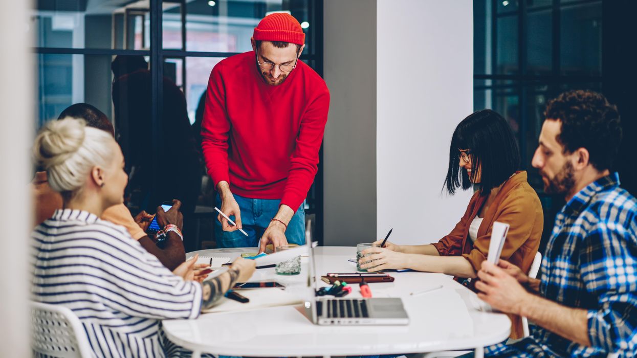 Employees working around a table.