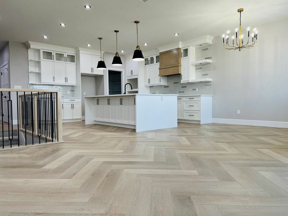 Empty kitchen with hardwood floors.