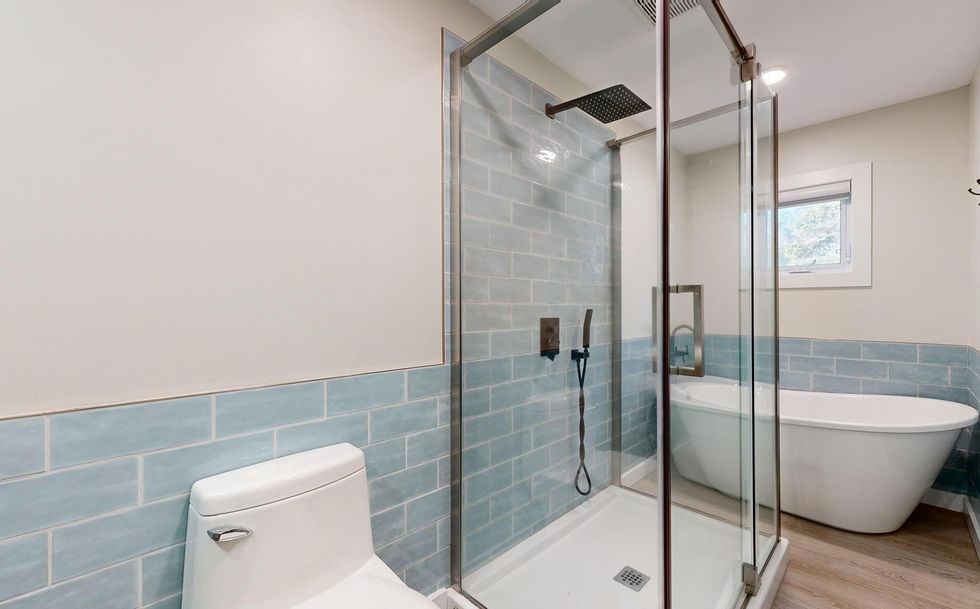 ensuit bathroom with a shower and soaker tub.