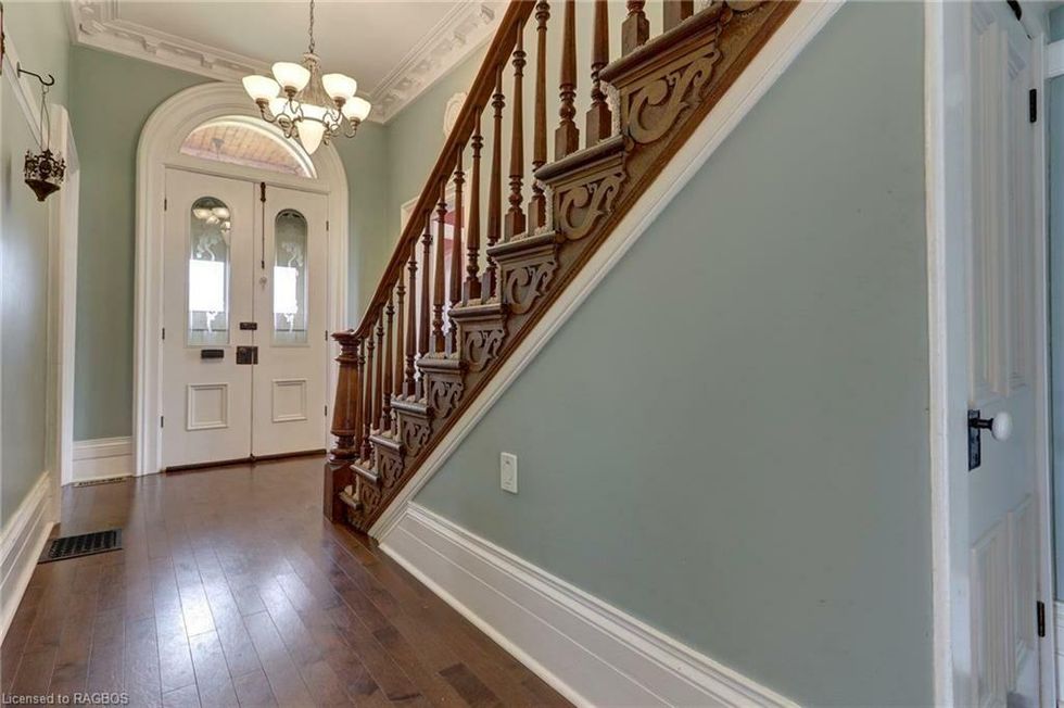 Entranceway with wooden staircase.