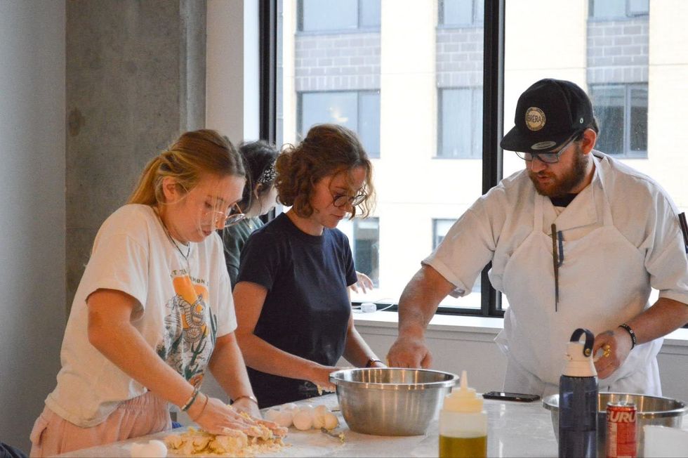 Envie residents participate in a complimentary cooking class.