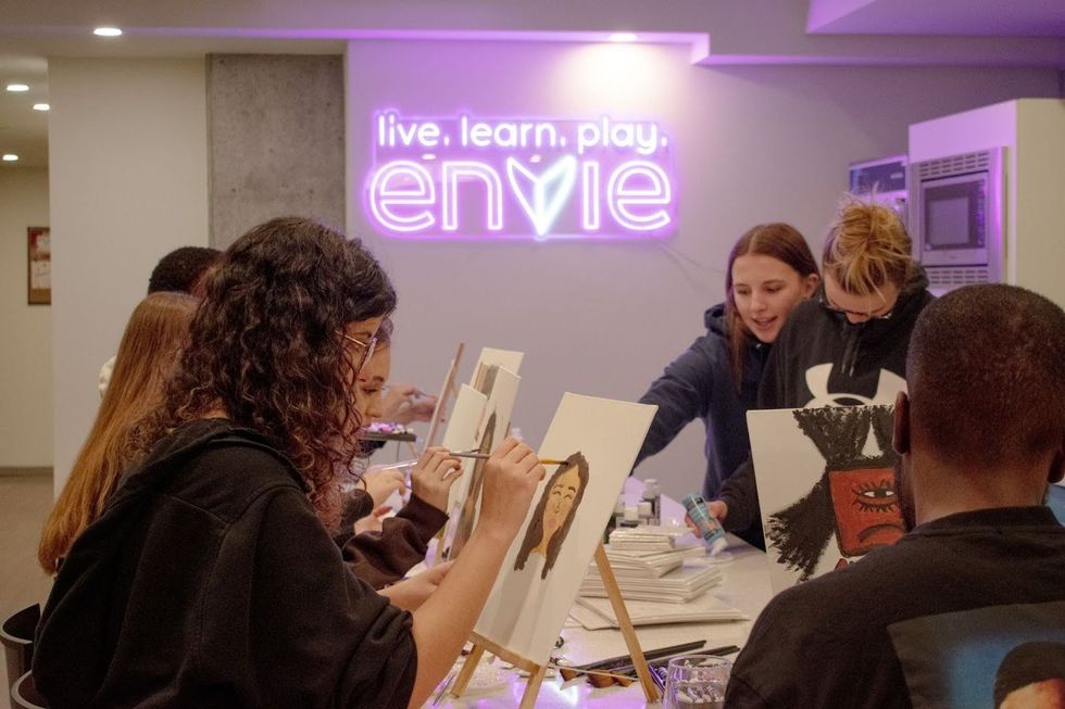 Envie residents participate in a complimentary paint and sip night.