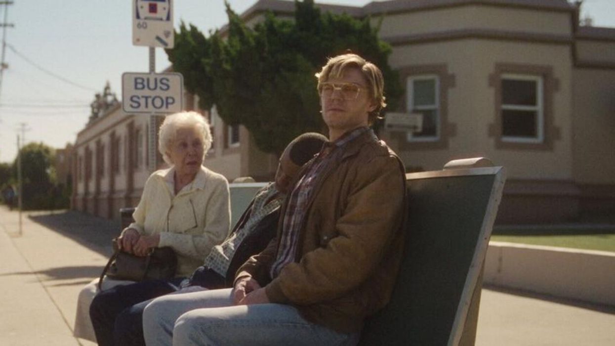 Evan Peters as Jeffrey Dahmer at a bus stop.