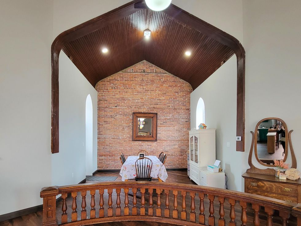Exposed brick and vaulted ceilings in dining area.