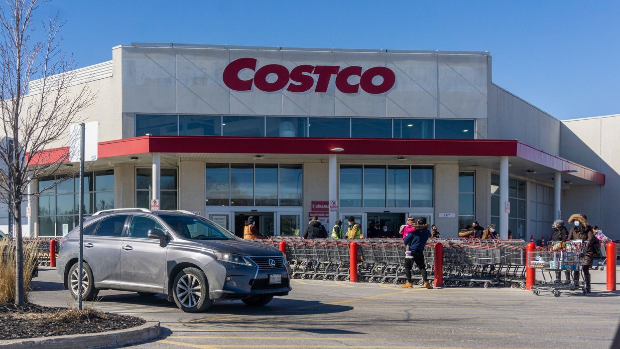 exterior of a costco store in ontario with a car driving by