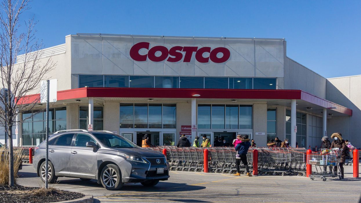 exterior of costco warehouse in canada with shoppers and a car