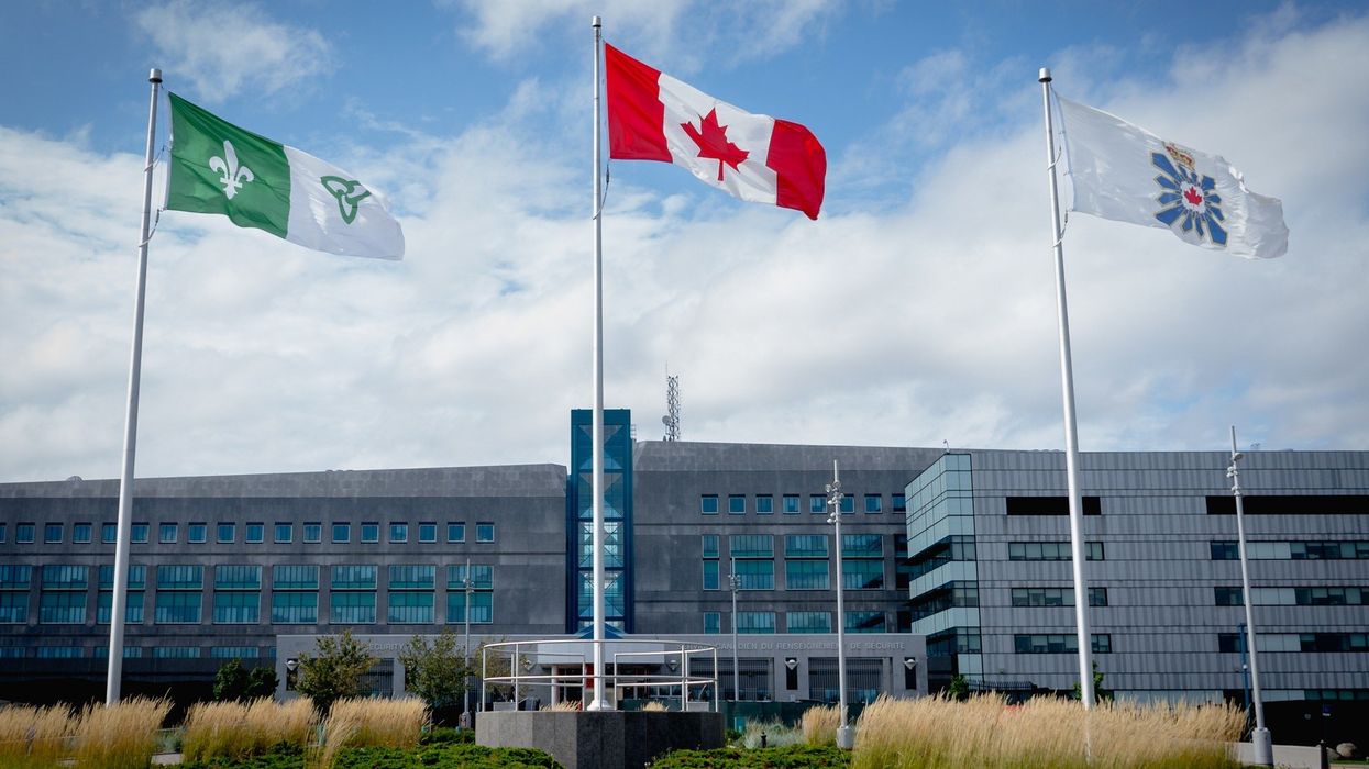 exterior of csis headquarters building in ottawa with canadian flag