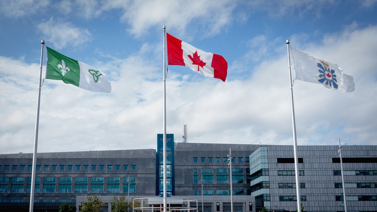 exterior of csis headquarters in ottawa with canadian, csis and franco-ontarian flags
